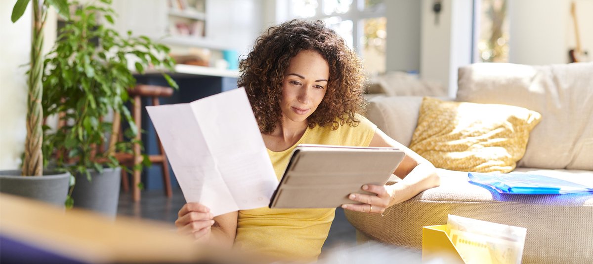 young-lady-looking-at-tab-and-document